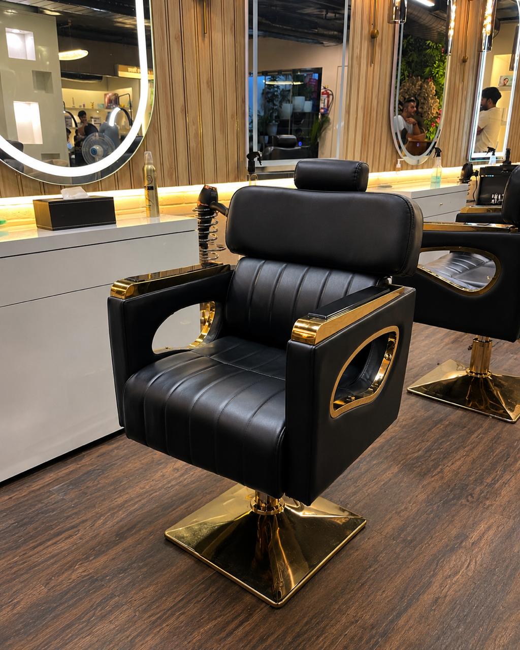 Black leather and brass barber chair on a polished salon floor